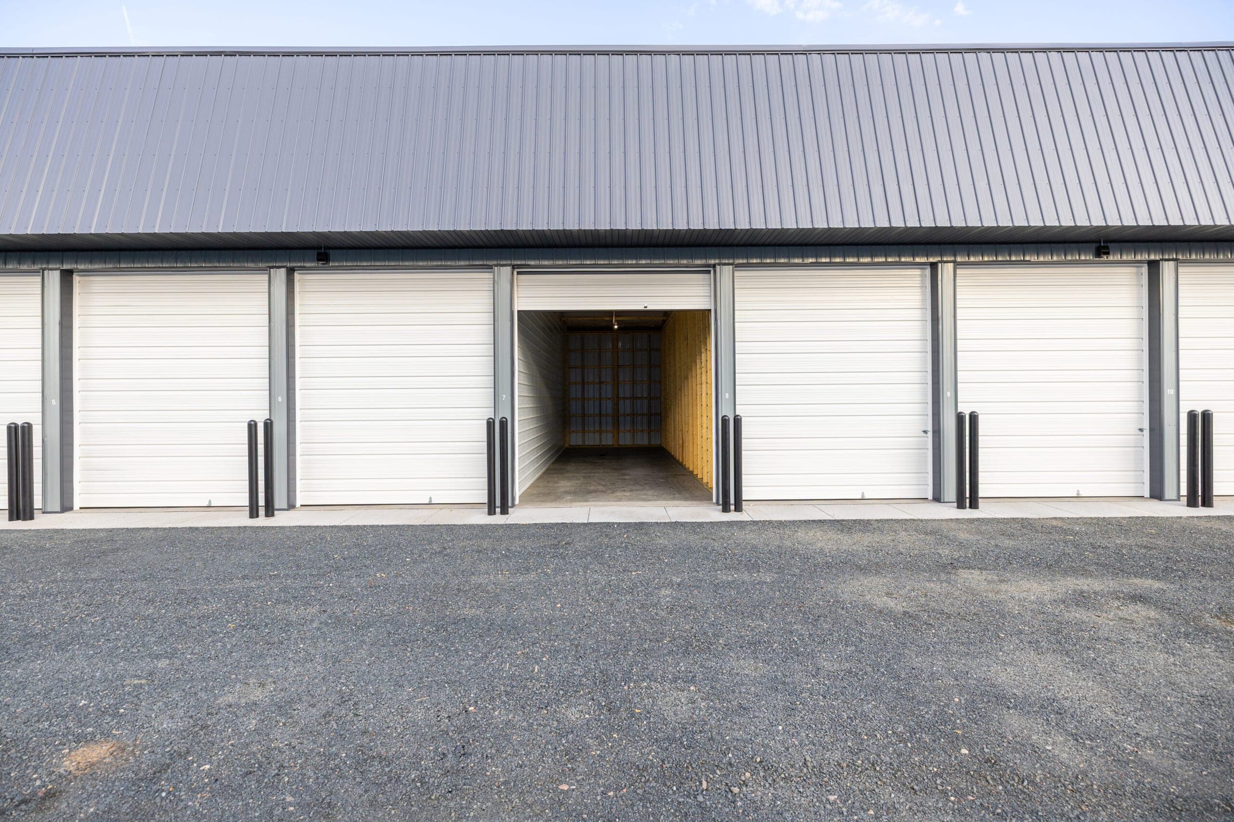 Storage building at Precision One with one overhead door open